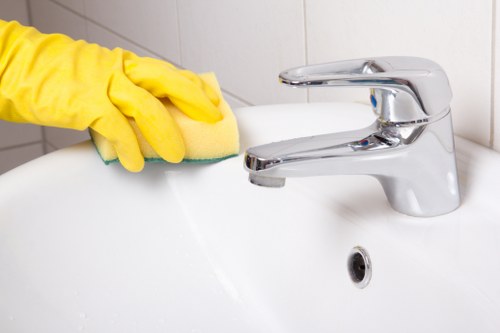 Staff member using protective gloves and equipment during carpet cleaning